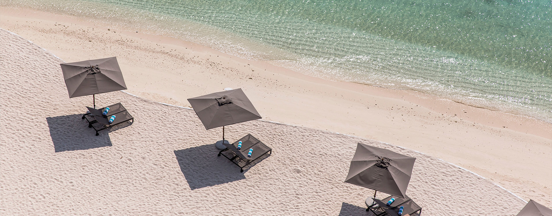 Amilla Beach Villa Residences - Beach umbrellas